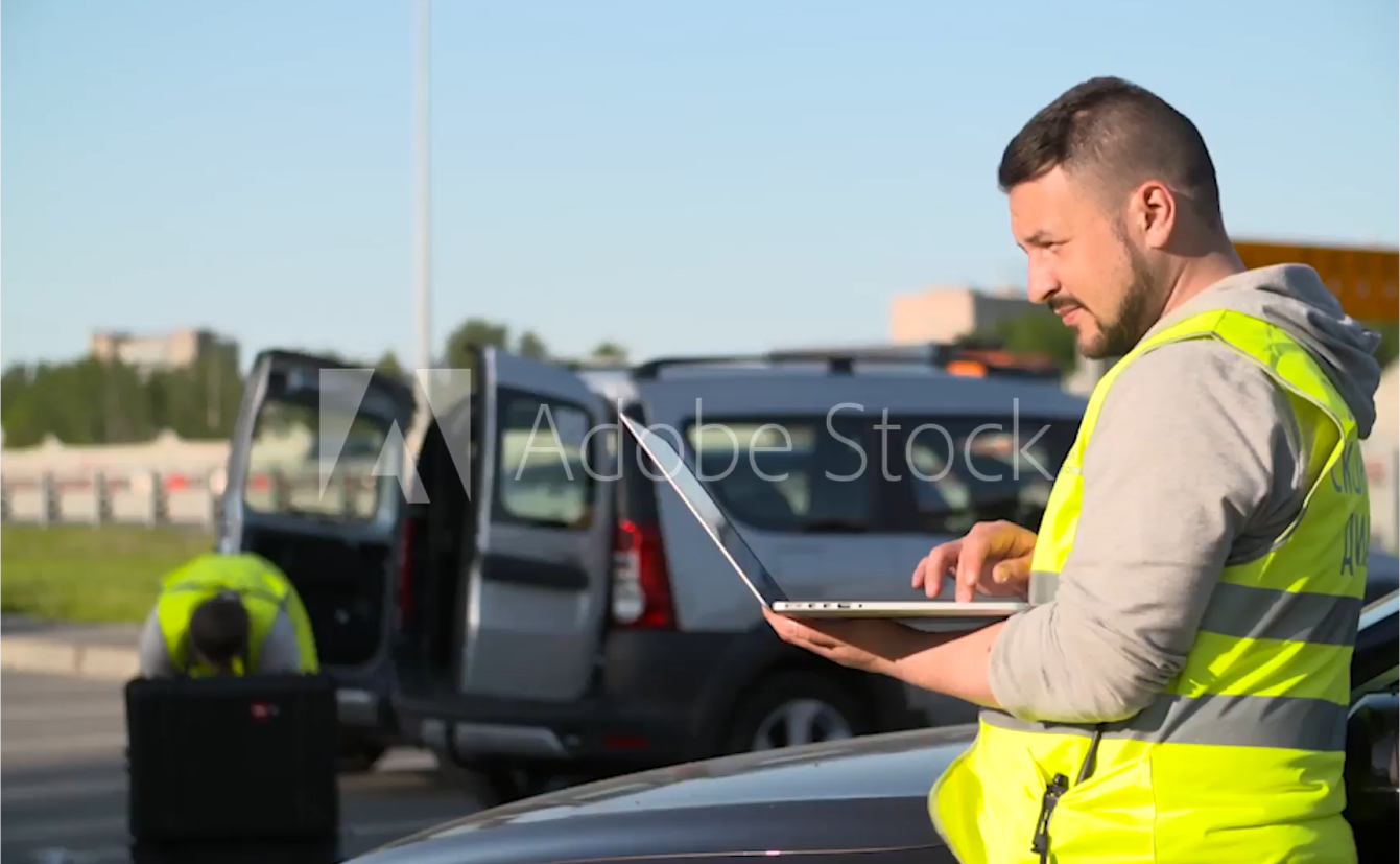 Roofing contractor holding a laptop, searching for SEO services of Elevation Marketing