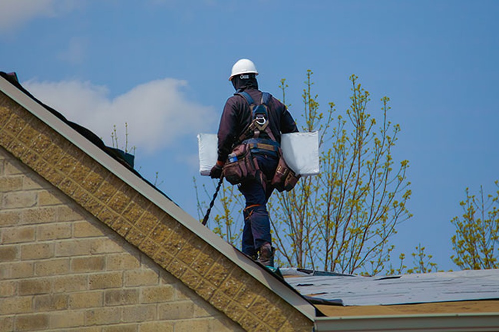 The approach to roofing shown by a professional roofer working on a roof by Elev Marketing in Omaha Roofers