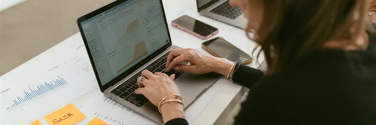 Professional reviewing analytics dashboard on laptop to improve strategies and get found online by Elevation Marketing