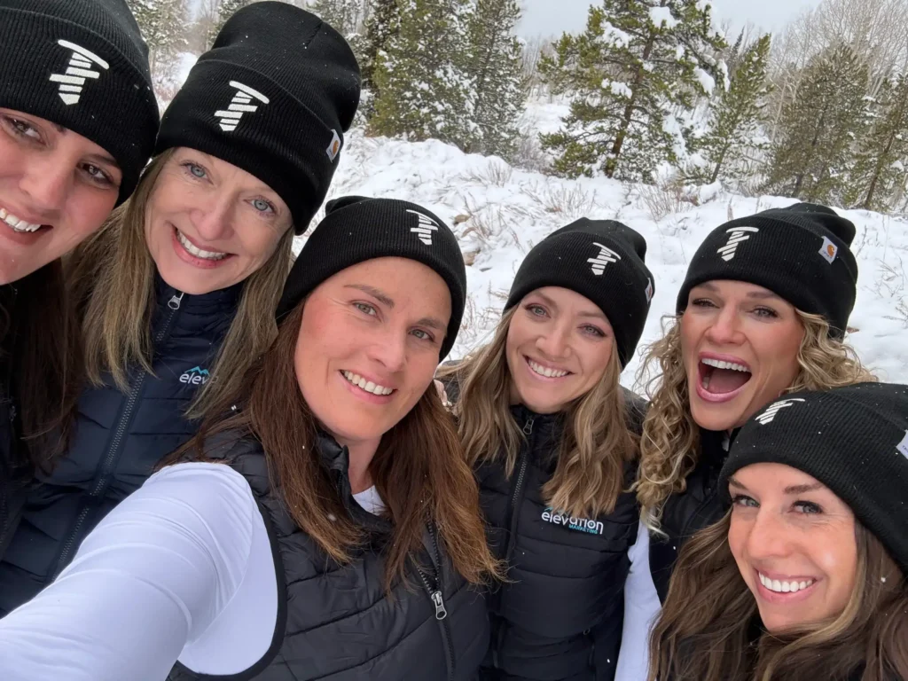 Elevation Marketing team smiling outdoors in winter, showcasing unity and expertise in entity SEO and modern AI-driven SEO strategies
