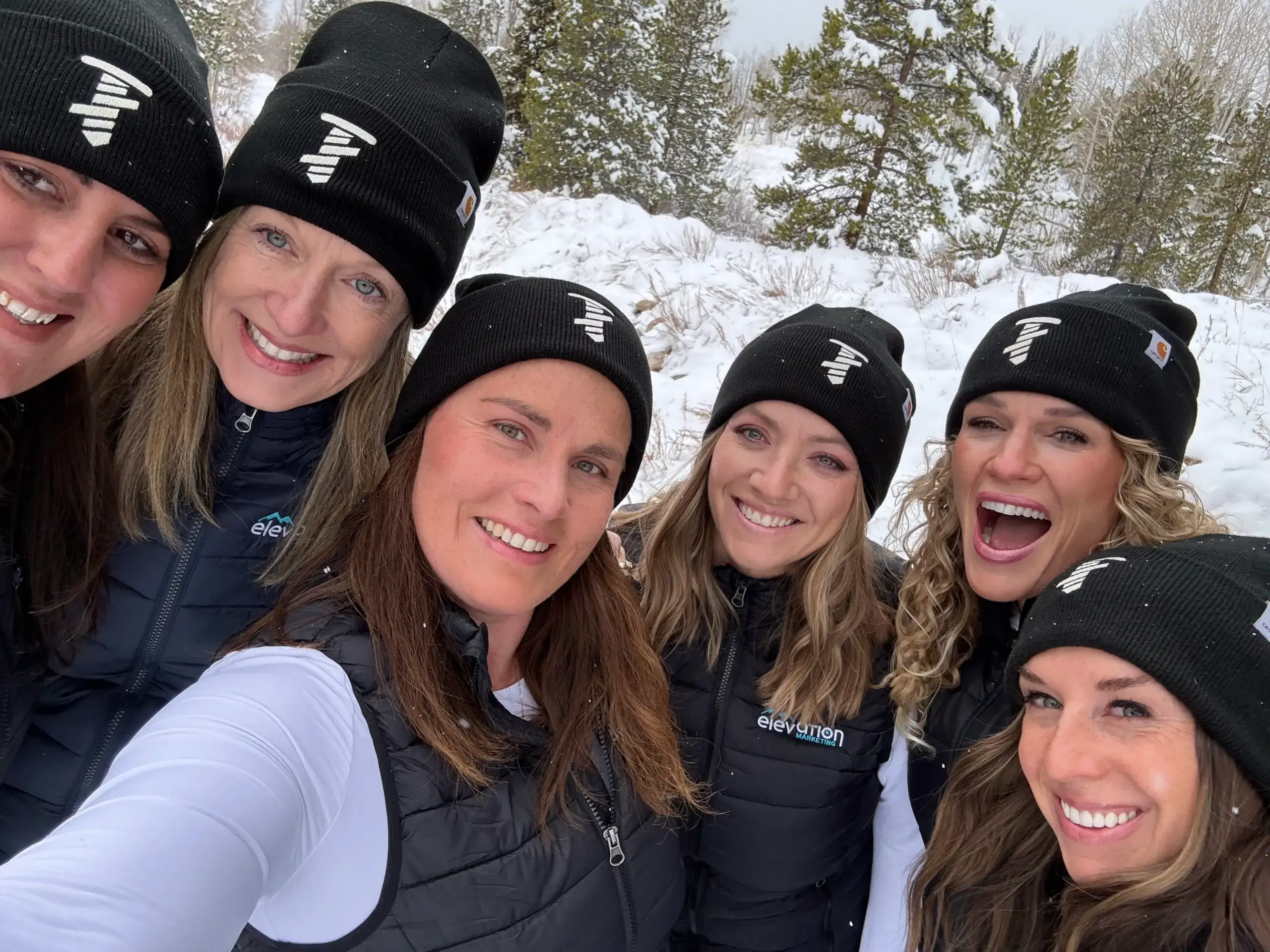 Elevation Marketing team smiling outdoors in winter, showcasing unity and expertise in entity SEO and modern AI-driven SEO strategies