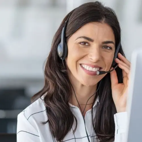 Customer service representative smiling while assisting clients with Google Local Service Ads Elevation marketing.