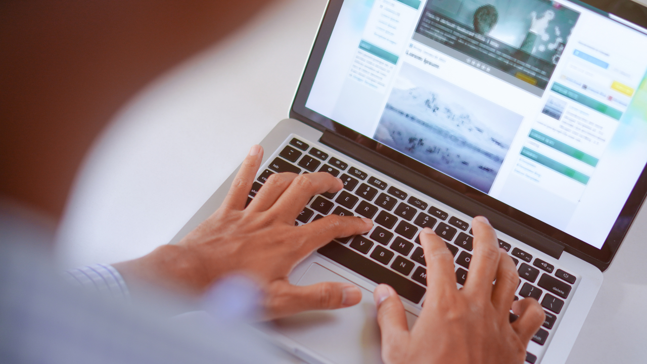 Person on computer reading a blog. “Content That Converts” and Elevation Marketing™ branding.