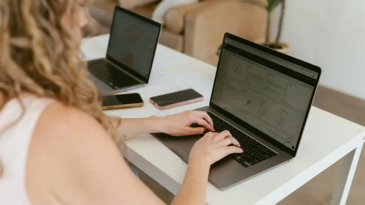 Marketing professional analyzing contractor lead generation data on laptop by Elevation Marketing