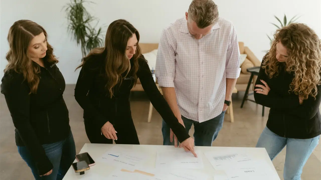 Marketing professionals collaborating on content marketing tips and analytics by Elevation Marketing™