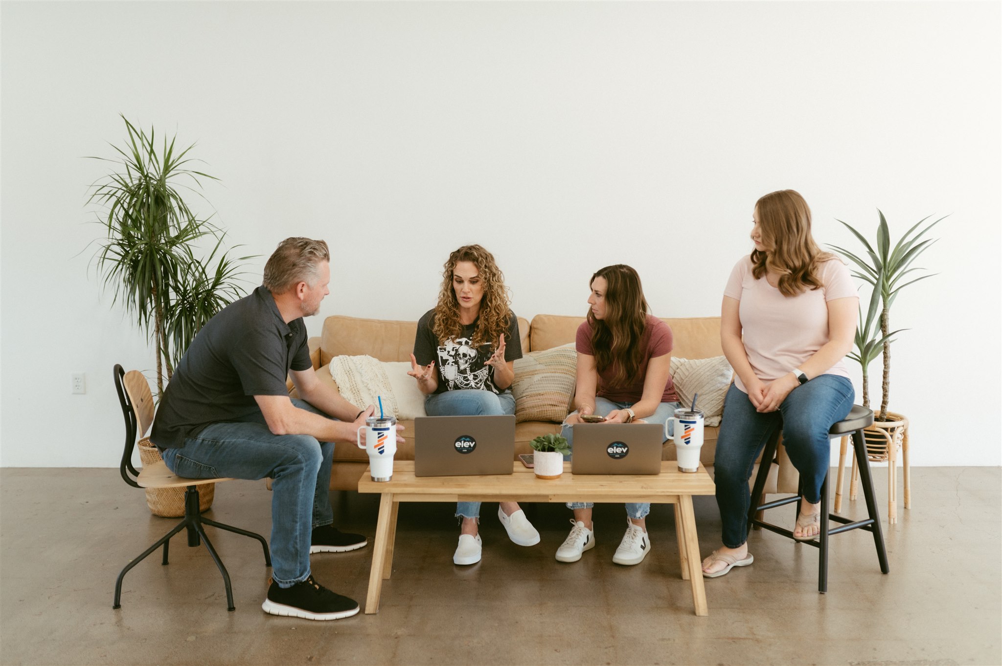 A team of professionals collaborates in an office lounge discussing lead nurturing strategies digital marketing in Denver by Elevation Marketing