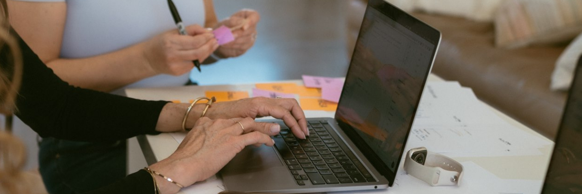 A team analyzing agency pricing models on a laptop to determine how much does contractor SEO cost contractor SEO in Denver by Elevation Marketing