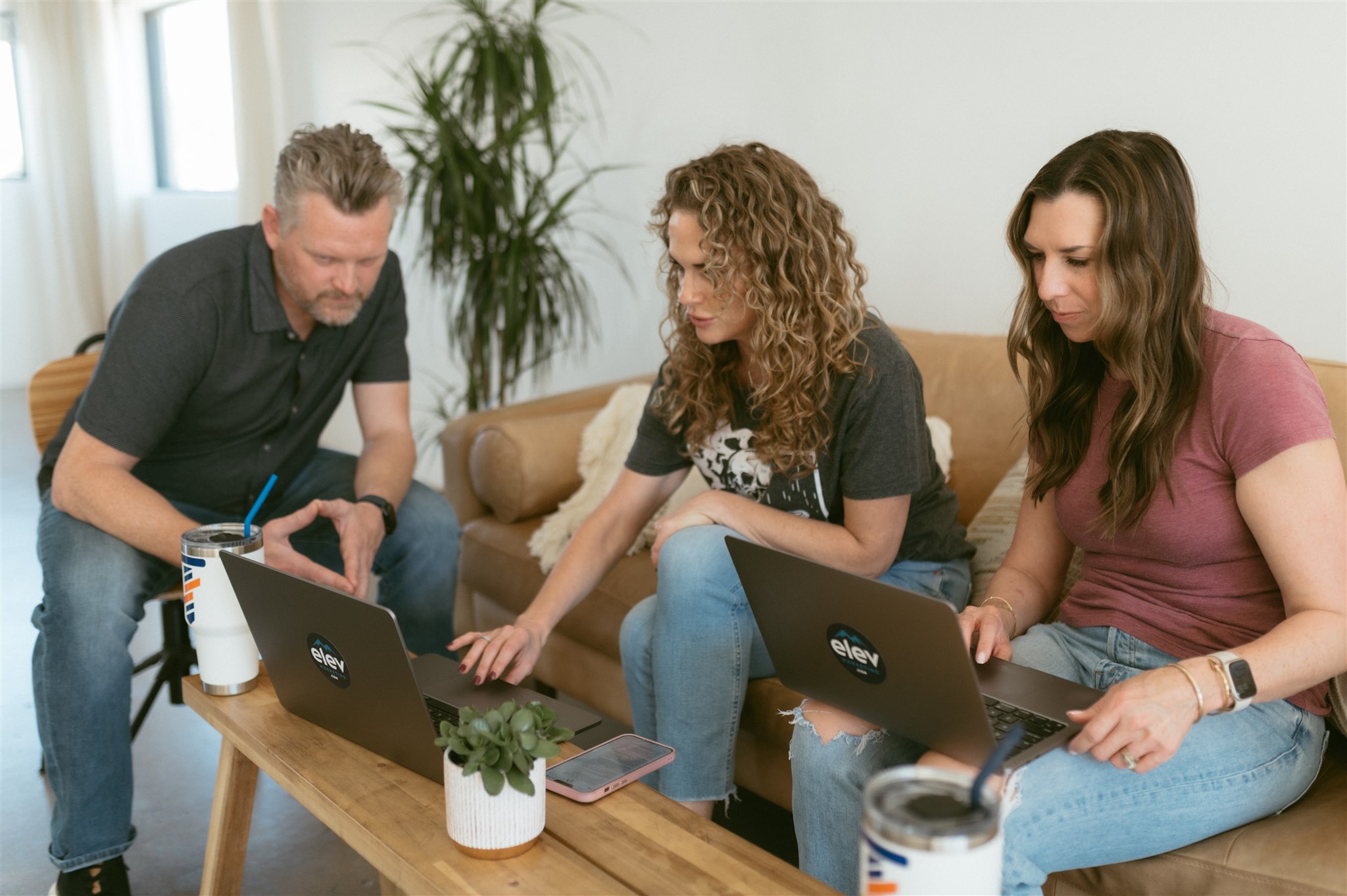 A marketing team reviewing agency budget estimates on laptops to determine how much does contractor SEO cost contractor SEO in Denver by Elevation Marketing