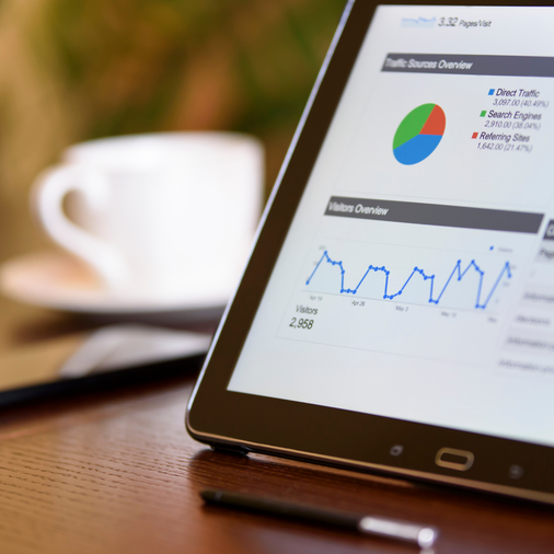 Tablet showing traffic sources and visitor overview charts highlighting Google Business Profile review policy updates service by Elevation Marketing