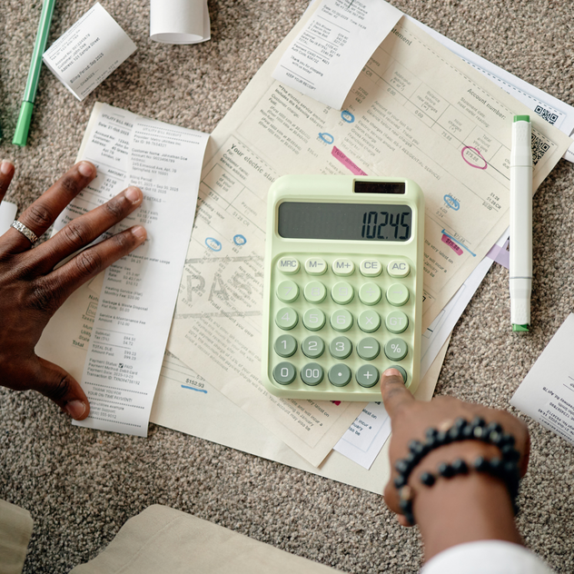 Hands calculating receipts and financial documents marketing expenses tax deductible for contractors accounting by Elevation Marketing