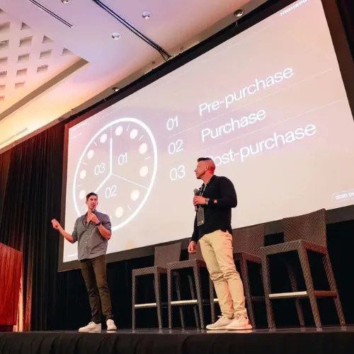 HighSpire CEO Paul Atherton presenting on stage at a construction business event, Trades Secrets podcast guest on construction company profitability with Elevation Marketing™